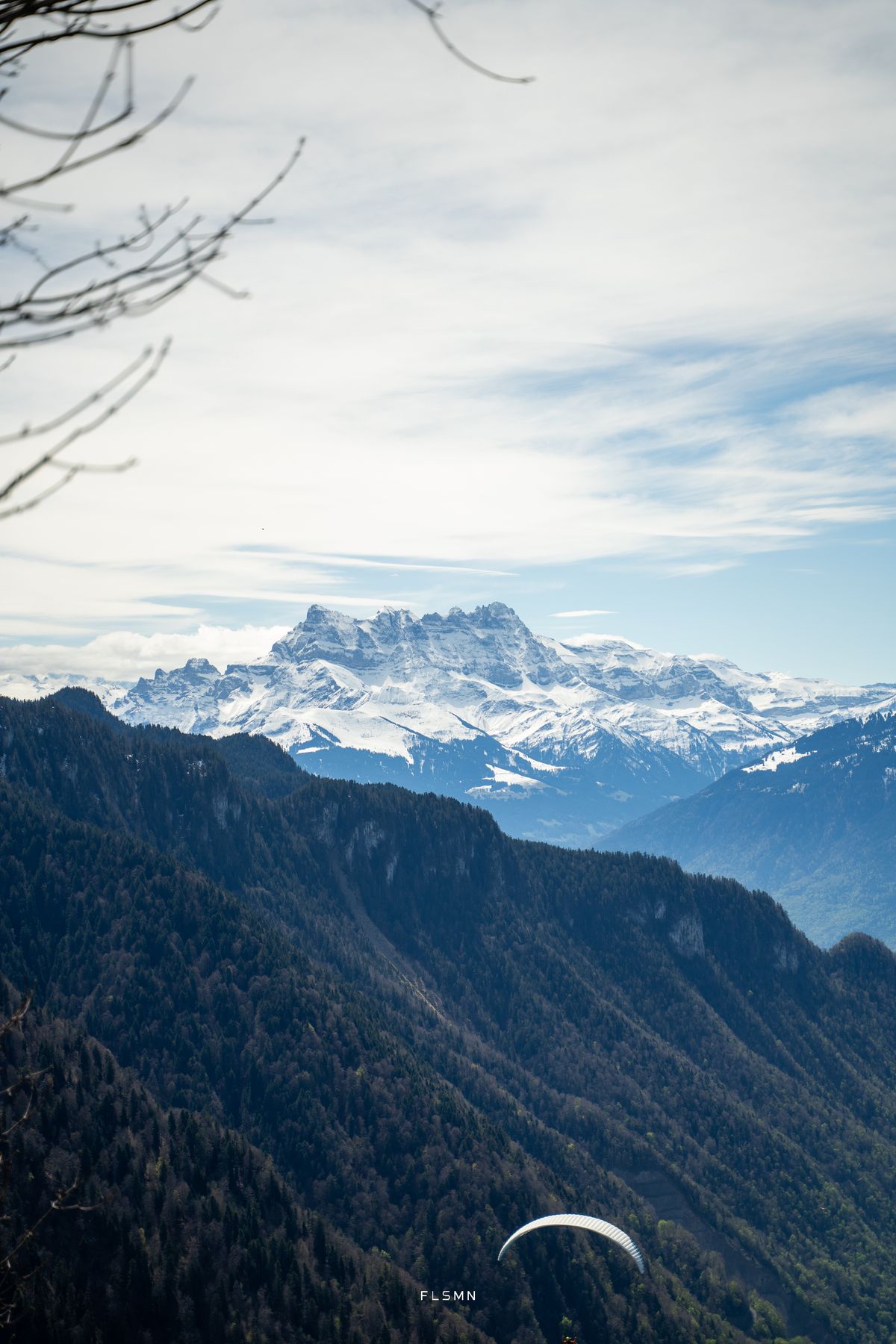 Dents du Midi seen from Glion with a paraglider below