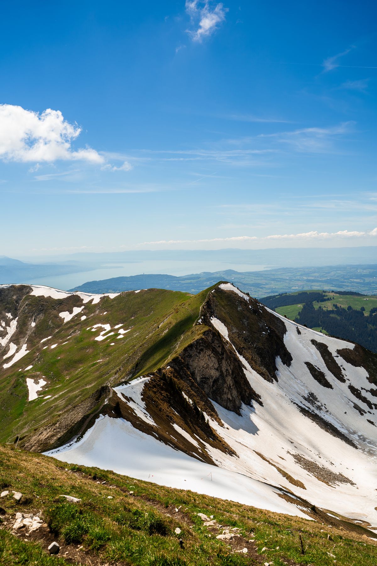 Snow-patched ridge from Le Moléson toward Lake Geneva