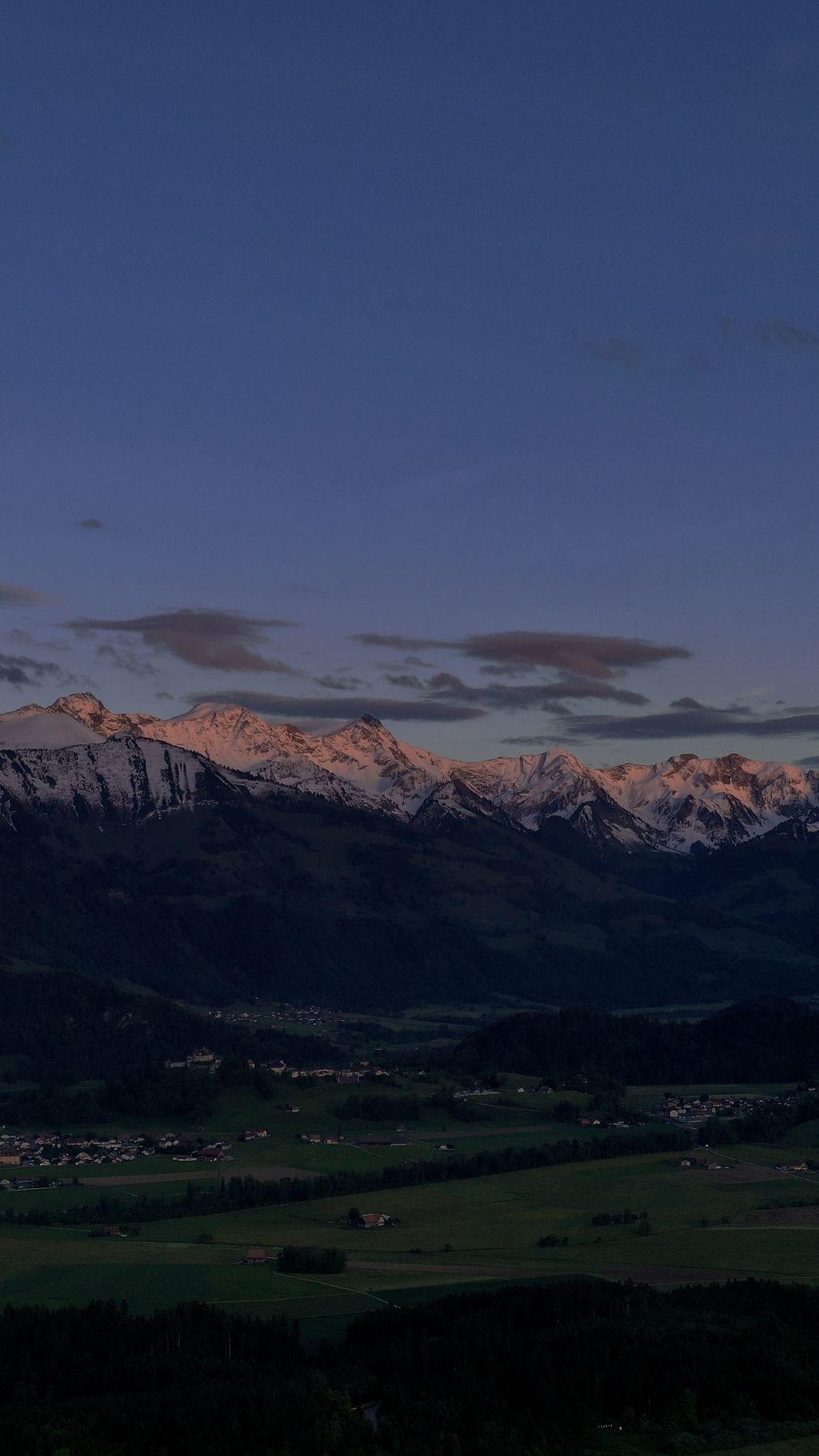 Pink alpenglow on the Vanil peaks above Gruyère
